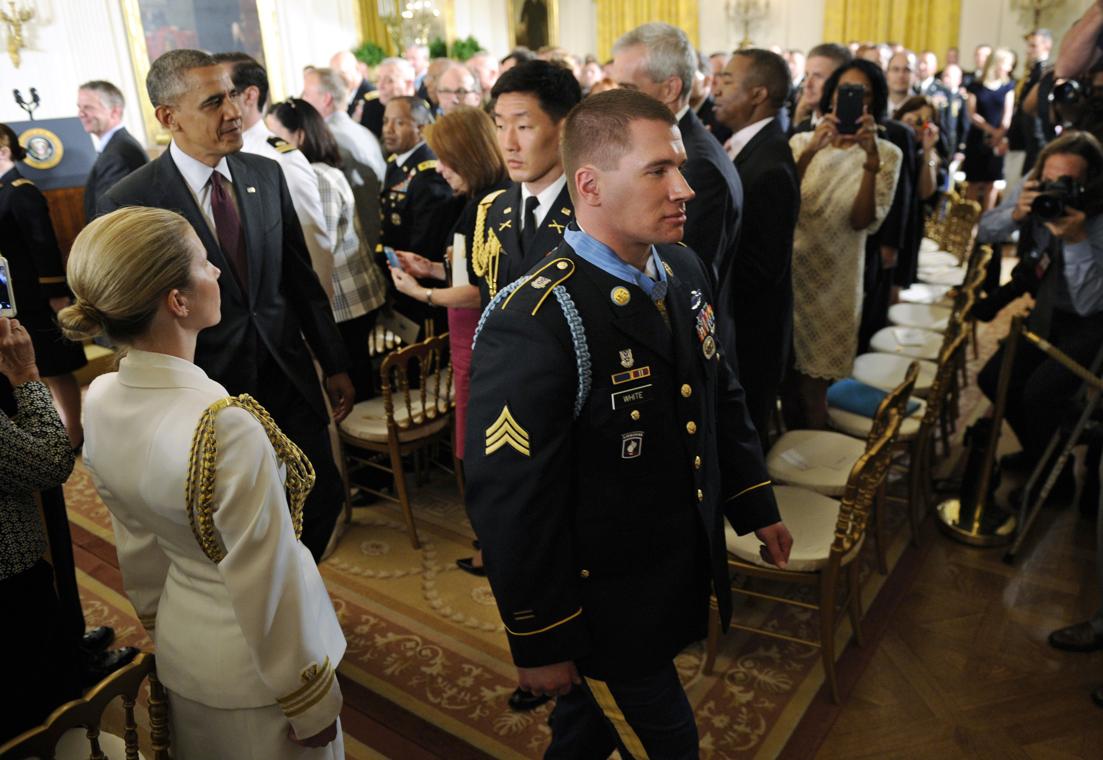 President Barack Obama follows the newest Medal of Honor recipient, former Army Sgt. Kyle J. White, following a ceremony in the East Room of the White House in Washington, Tuesday, May 13, 2014. White is a former Army sergeant who saved a fellow soldier's life and helped secure the evacuation of other wounded Americans while under persistent fire during a 2007 ambush in Afghanistan. White is the seventh living recipient to be awarded the Medal of Honor for actions in Iraq or Afghanistan. (AP Photo)