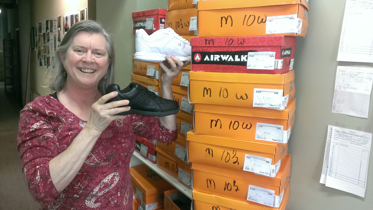 Terre Thomas, executive director of Small Sums in Saint Paul, keeps boxes of shoes for workers who need them to accept jobs they've been offered.