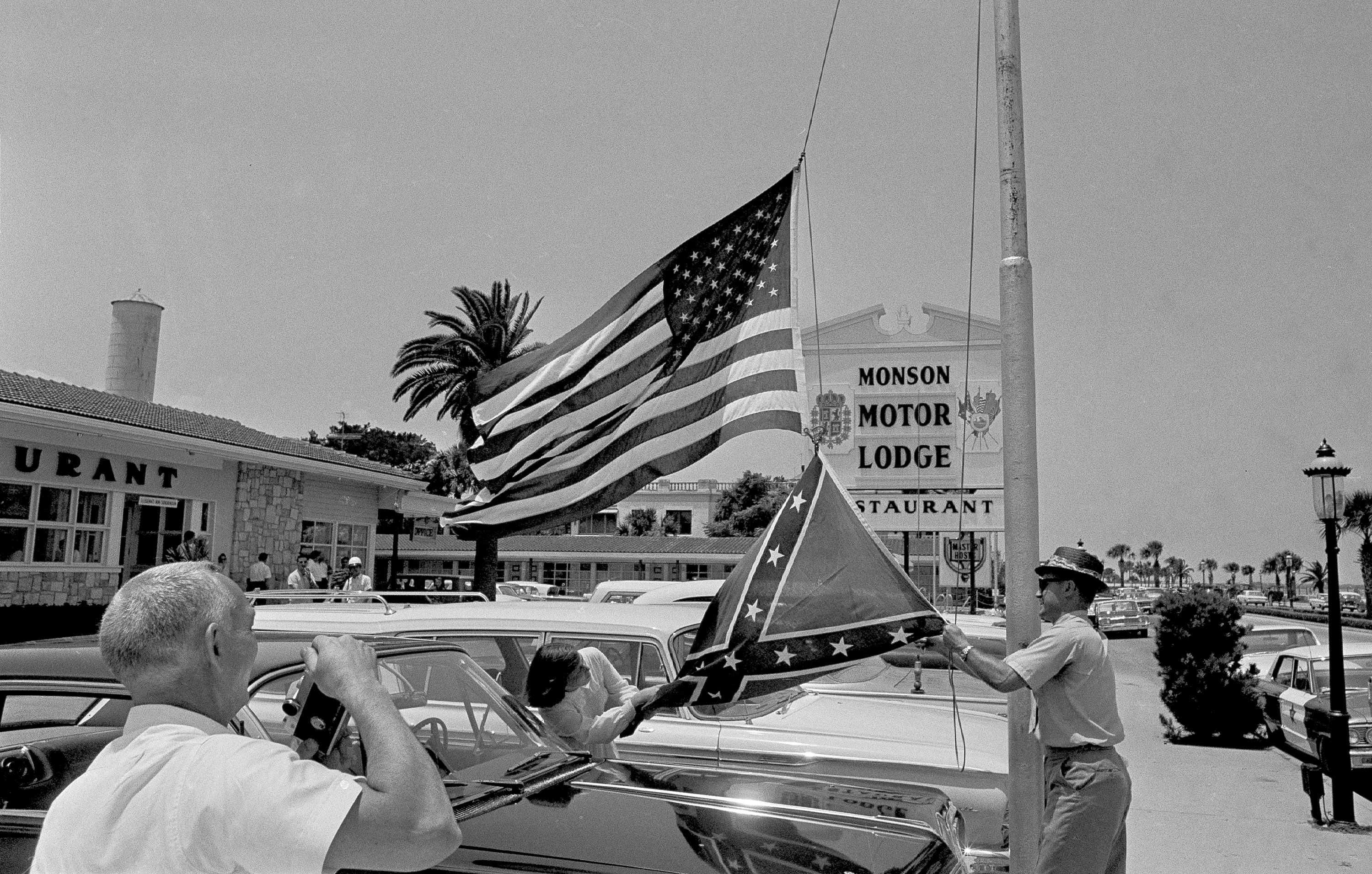 Motel and restaurant owner James Brock and his daughter, Robin, 13, raise a confederate flag in front of the Monson Motor Lodge in St. Augustine, Fla., June 19, 1964.  The motel has been a target of integrationists for several weeks.  (AP Photo)