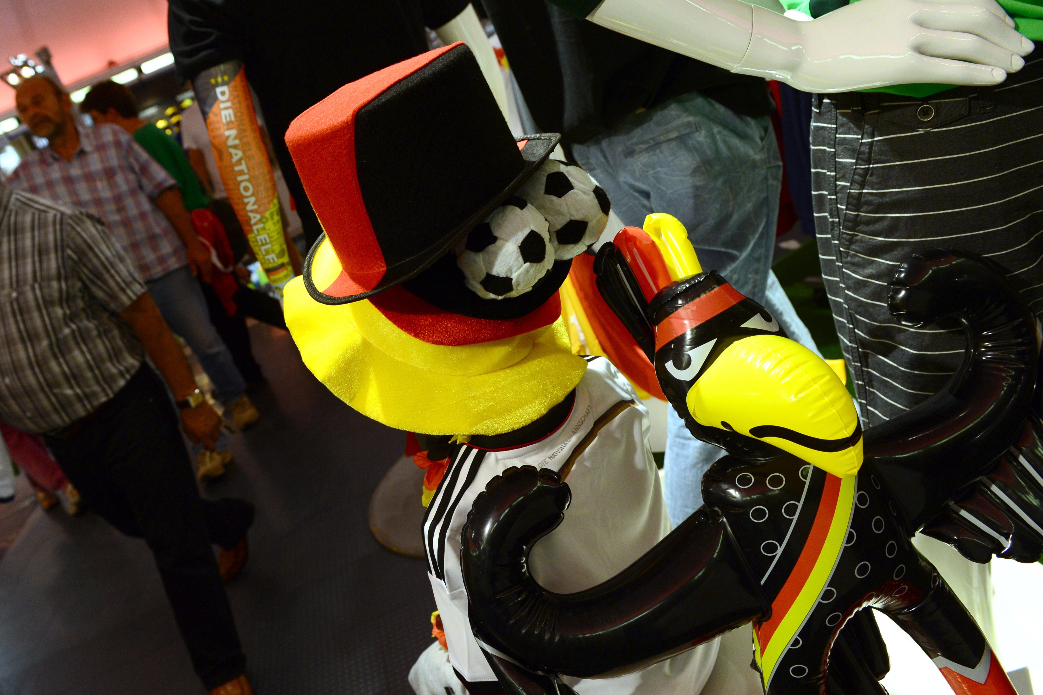Outfits and fans accessories featuring the German national colours are on display at a Sports department store in Berlin on July 10, 2014, three days before the football World Cup 2014 final game between Germany and Argentina, to be played in Brazil. AFP PHOTO / JOHN MACDOUGALL