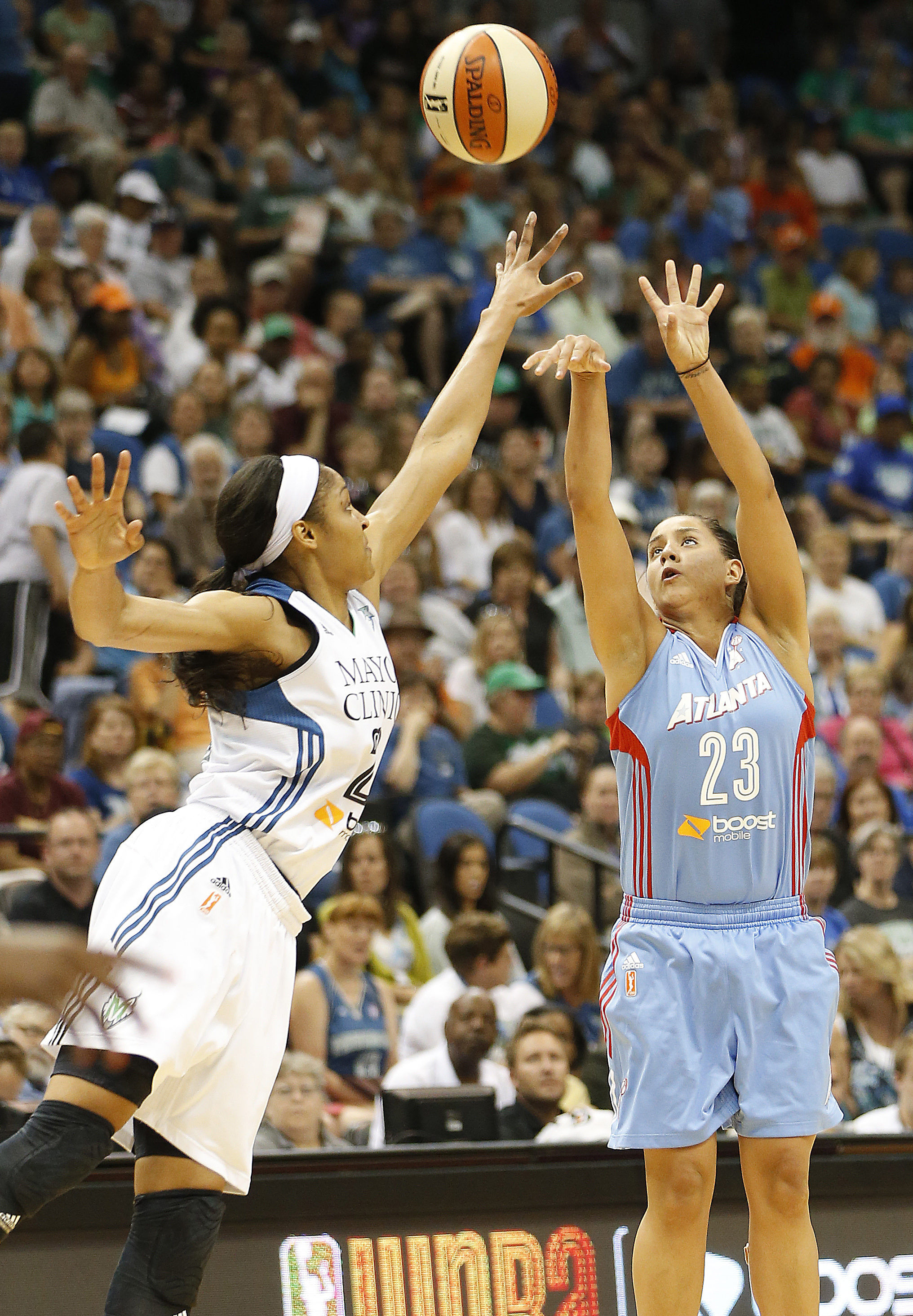 Atlanta Dream guard Shoni Schimmel (23) shoots the ball against Minnesota Lynx forward Maya Moore (23) in the first half of a WNBA basketball game on Tuesday. Photo:  Stacy Bengs/Associated Press.