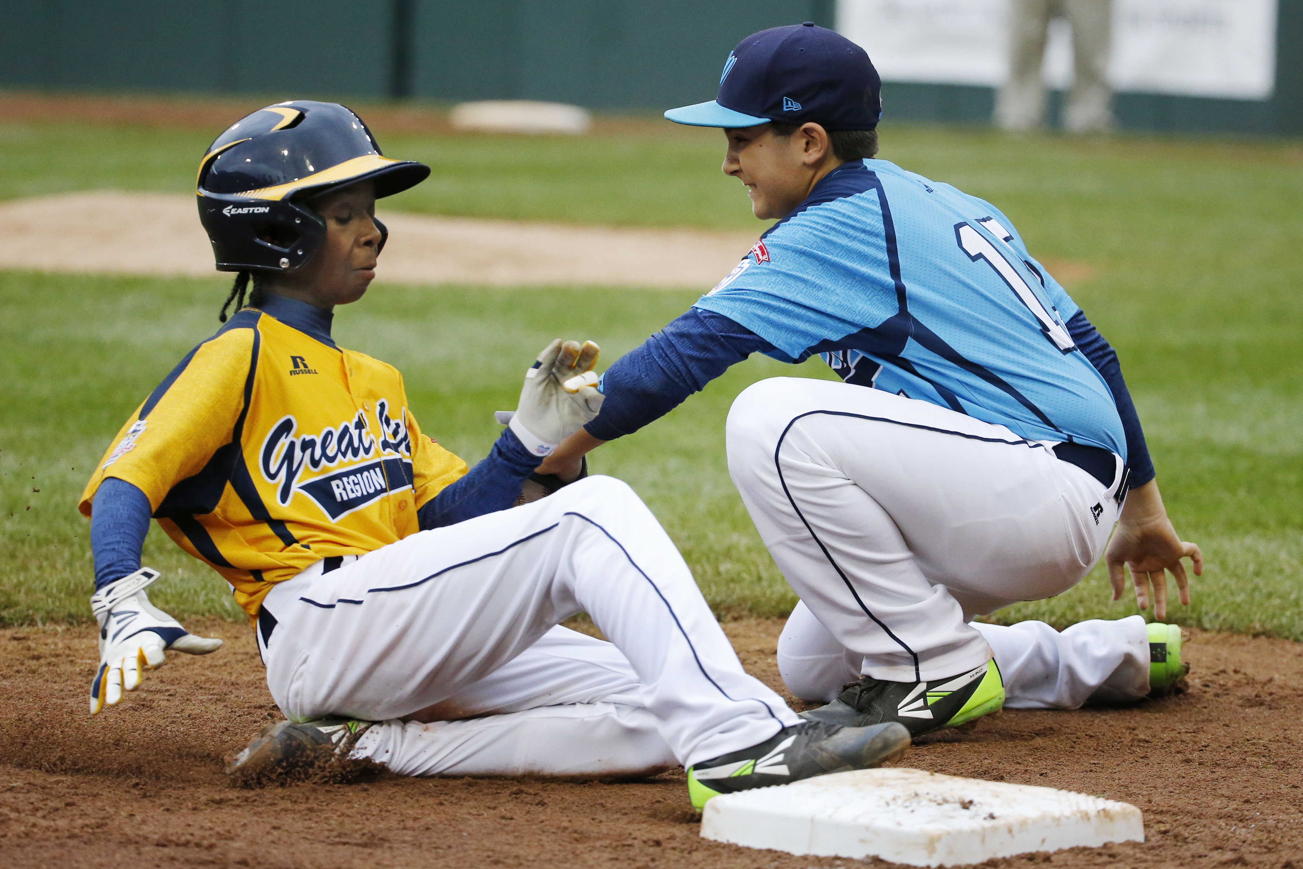 Chicago's Jaheim Benton, left, slides safely into third ahead of the tag by Las Vegas' Dillon Jones in the fifth inning of the United States Championship game at the Little League World Series tournament in South Williamsport, Pa., Saturday, Aug. 23, 2014. Chicago won 7-5. (AP Photo/Gene J. Puskar