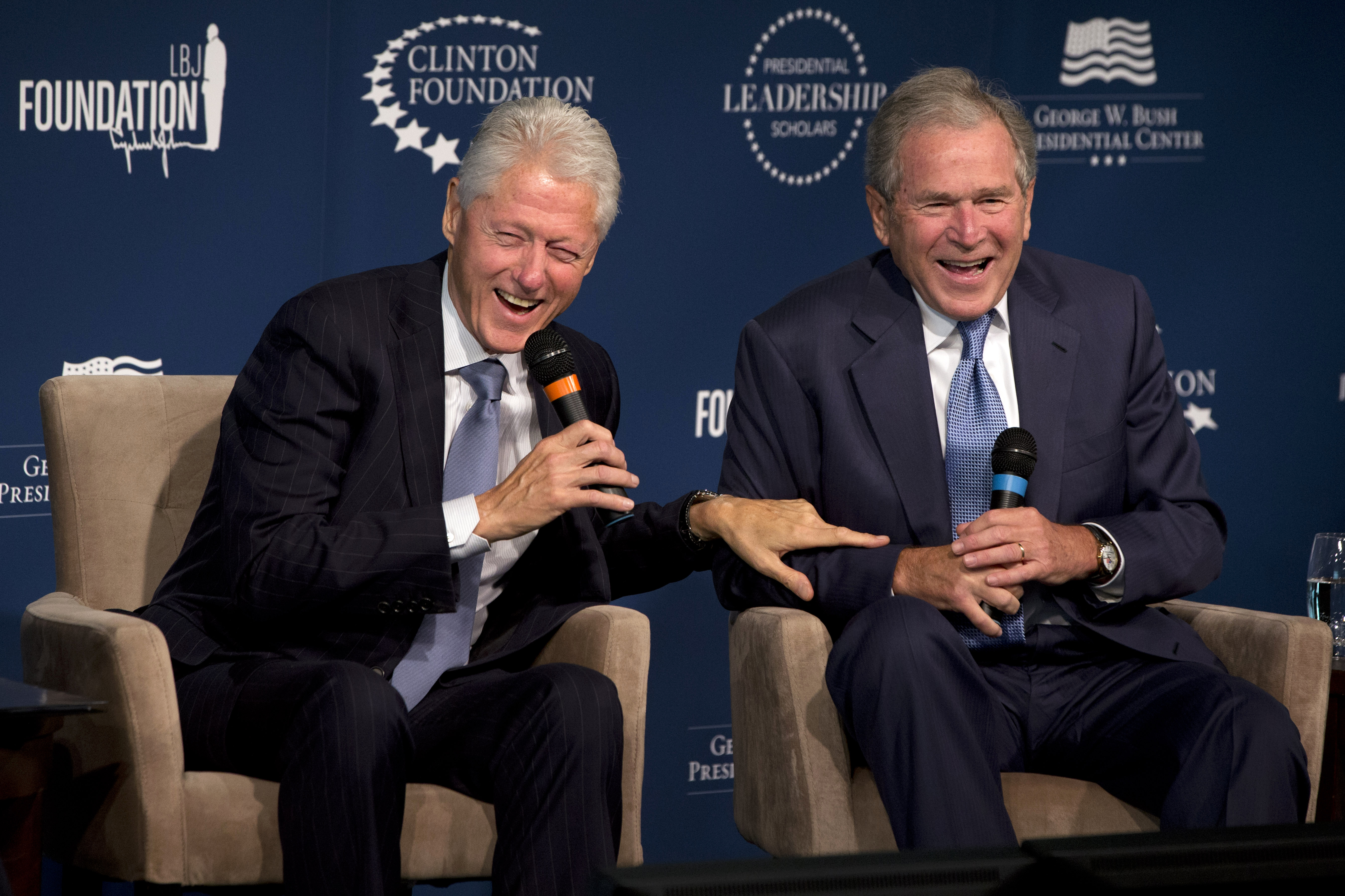 Former Presidents Bill Clinton, left, and George W. Bush, laugh while participating in the Presidential Leadership Scholars Program Launch, Monday, Sept. 8, 2014, at The Newseum in Washington. The two are launching a new scholars program at four presidential libraries, aiming to help academics and business leaders learn more about presidential leadership.  (AP Photo/Jacquelyn Martin)