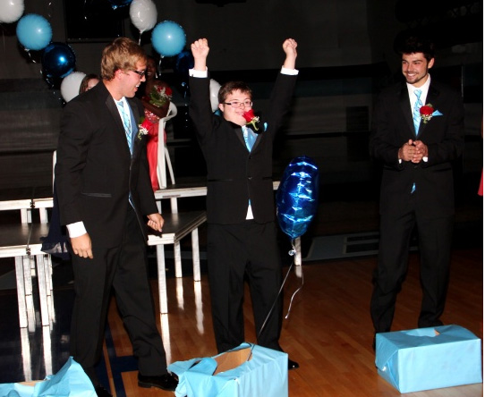 Brock Shepard punched open his cardboard box and released a helium balloon, the signal that he had been chosen Blaine High School homecoming king. Shepard celebrates while candidates Joey Blommer and Logan Nelson applaud his victory. (Photo by Sue Austreng, ABC Newspapers)