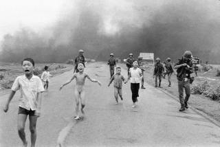 South Vietnamese forces follow after terrified children, including 9-year-old Kim Phuc, center, as they run down Route 1 near Trang Bang after an aerial napalm attack on suspected Viet Cong hiding places, June 8, 1972. A South Vietnamese plane accidentally dropped its flaming napalm on South Vietnamese troops and civilians. The terrified girl had ripped off her burning clothes while fleeing. The children from left to right are: Phan Thanh Tam, younger brother of Kim Phuc, who lost an eye, Phan Thanh Phouc, youngest brother of Kim Phuc, Kim Phuc, and Kim's cousins Ho Van Bon, and Ho Thi Ting. Behind them are soldiers of the Vietnam Army 25th Division. (AP Photo/Nick Ut)