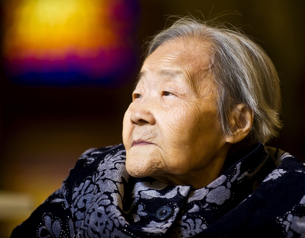 In this photo taken on Tuesday, Oct. 28, 2014, 97-year-old Chengyi Pan, an immigrant hailing from Tianjin, China, poses for a photo in Winona, Minn. Pan, a retired physics teacher and middle school vice-principal, came to the United States in 2009 after the death of her husband and was granted citizenship in September. She will vote for the first time in November's election. (AP Photo/The Winona Daily News, Jacob Hilsabeck)