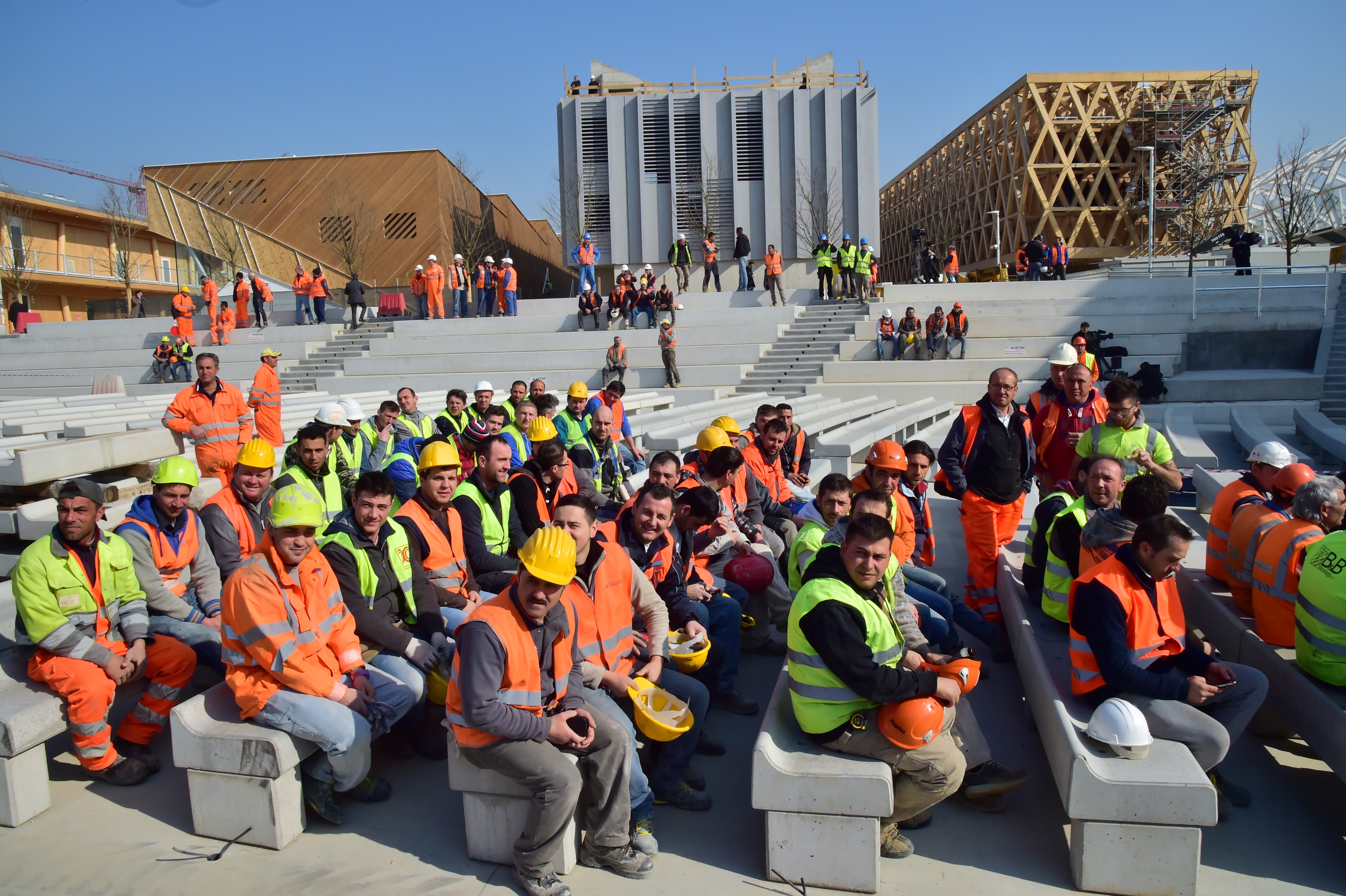 Workers wait for the arrival of Italian Prime Minister Matteo Renzi for a visit at the construction site of the Universal Exhibition 2015 (Expo Milano 2015 or World Exposition 2015) in Milan on March 13, 2015. The exhibition will run from May 1st, 2015 to October 31, 2015 on the theme Feeding the Planet, Energy for Life. The fair focuses on food security, sustainable agricultural practices, nutrition and battling hunger - as well as on dishing out the best fare of the world's culinary cultures.  Photo: GIUSEPPE CACACE/AFP/Getty Images.