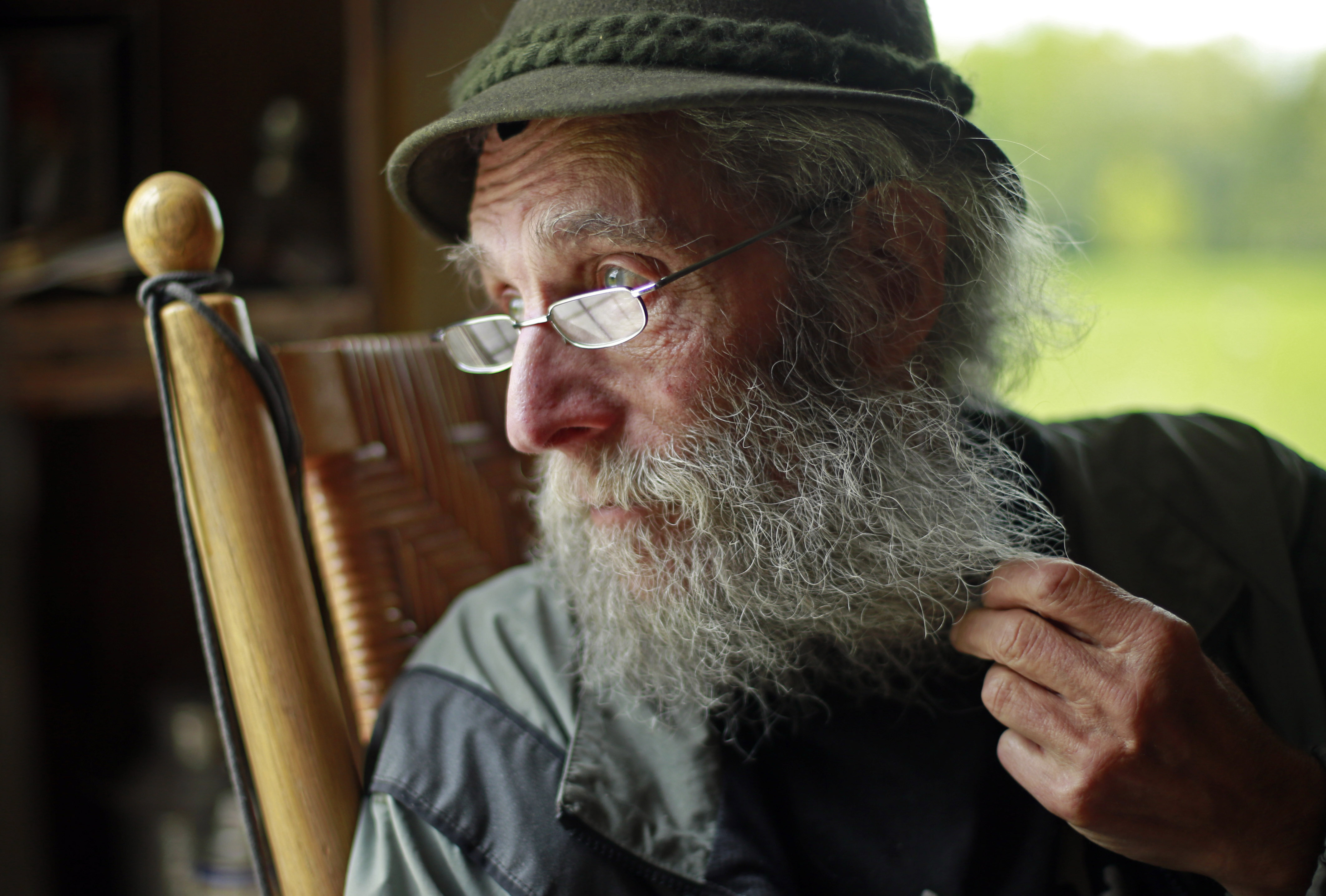  In a May 23, 2014, file photo, Burt Shavitz pauses during an interview to watch a litter of fox kits play near his camp in Parkman, Maine. Shavitz, a former beekeeper, is the Burt behind Burt's Bees. A spokeswoman for Burts Bees said Shavtiz died Sunday, July 5, 2015, at his home in rural Maine. He was 80. (AP Photo/Robert F. Bukaty, File)