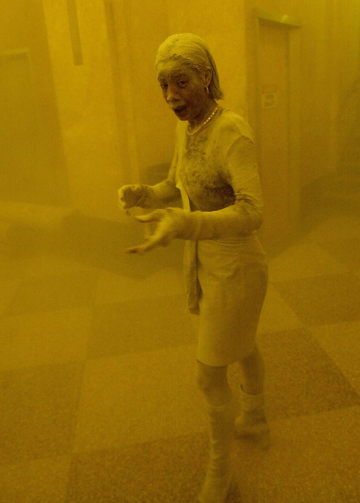 This 11 September 2001 file photo shows Marcy Borders covered in dust as she takes refuge in an office building after one of the World Trade Center towers collapsed in New York. Borders was caught outside on the street as the cloud of smoke and dust enveloped the area. (Photo:  STAN HONDA/AFP/Getty Images)