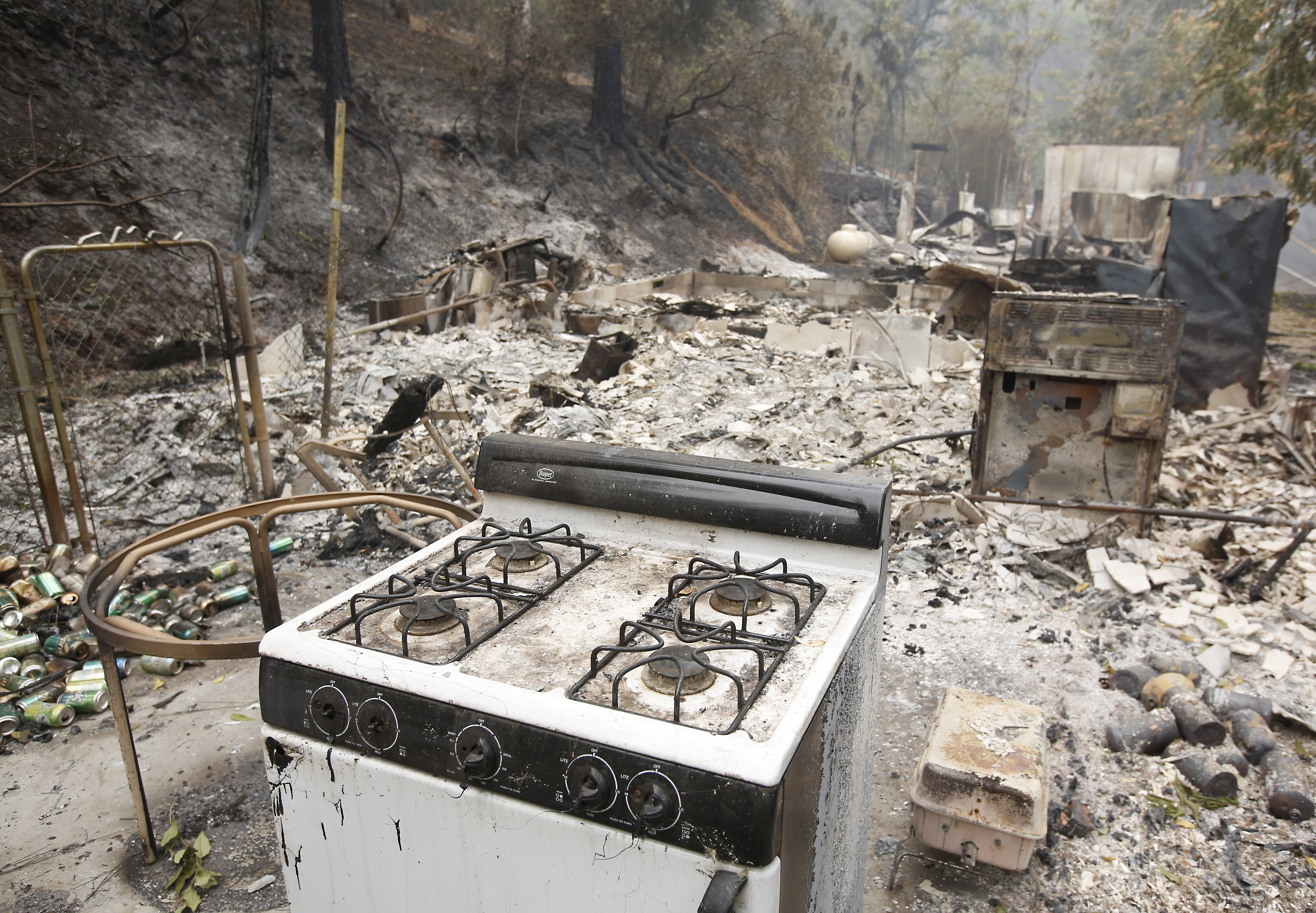 A kitchen stove sits among the remains of  home, Sunday, Sept. 13, 2015, destroyed by a fire near Mokelumne Hill, Calif. Two of California's fastest-burning wildfires in decades overtook several Northern California towns, destroying homes and sending residents fleeing. (AP Photo/Rich Pedroncelli)