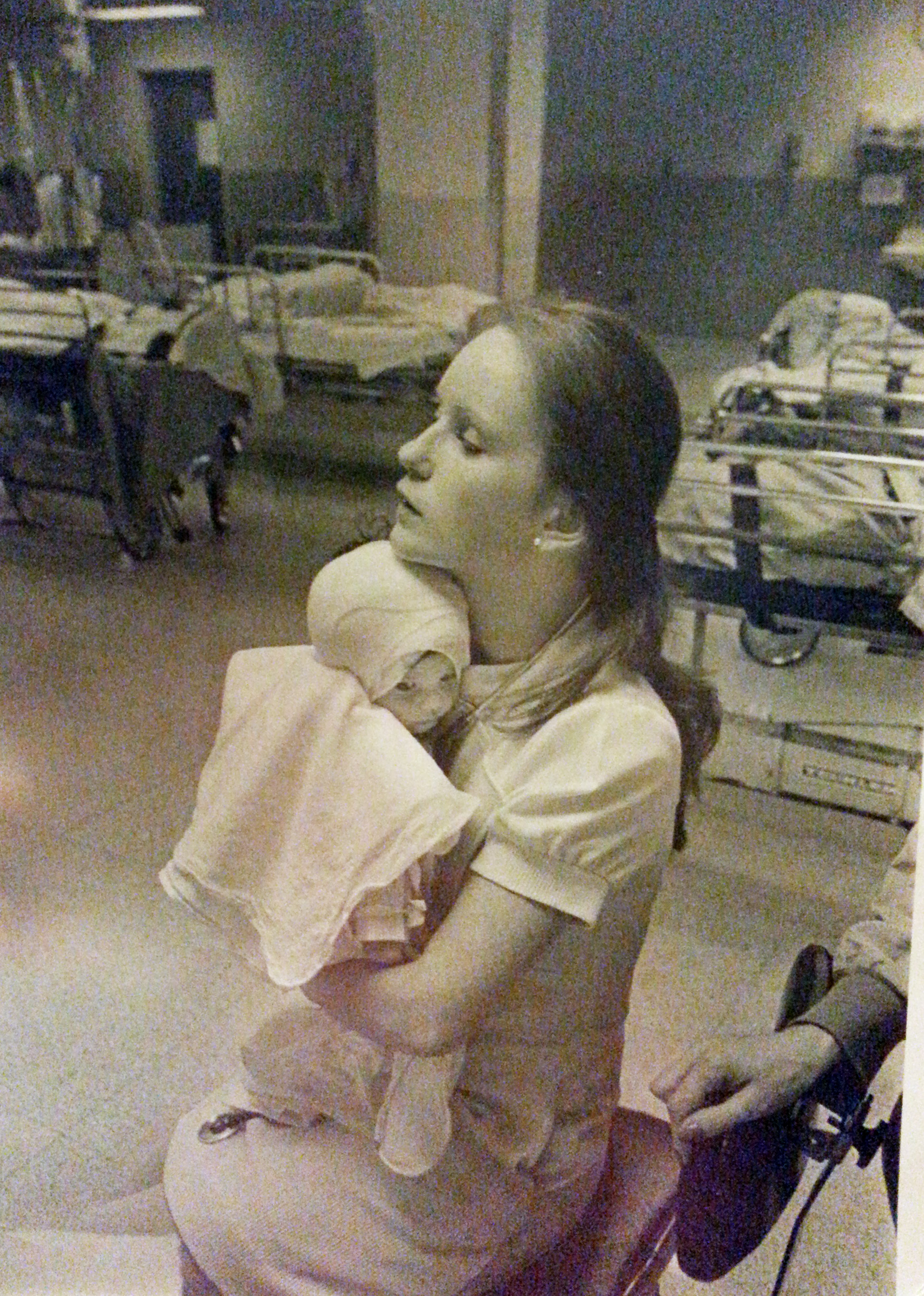 In this 1977 photo provided by Albany Medical Center, nurse Susan Berger cuddles infant Amanda Scarpinati, who had been severely burned by a steam vaporizer at home, in the pediatric unit at Albany Medical Center in Albany N.Y. Scarpinati kept the hospitals annual report that published the photo and was comforted by the picture when she was bullied for her burn scars as a child. She recently used social media to learn Bergers identity so she could thank her for her loving care. Albany Medical Center has arranged for the two women to meet on Tuesday, Sept. 29, 2015. (Carl Howard/Albany Medical Center via AP)