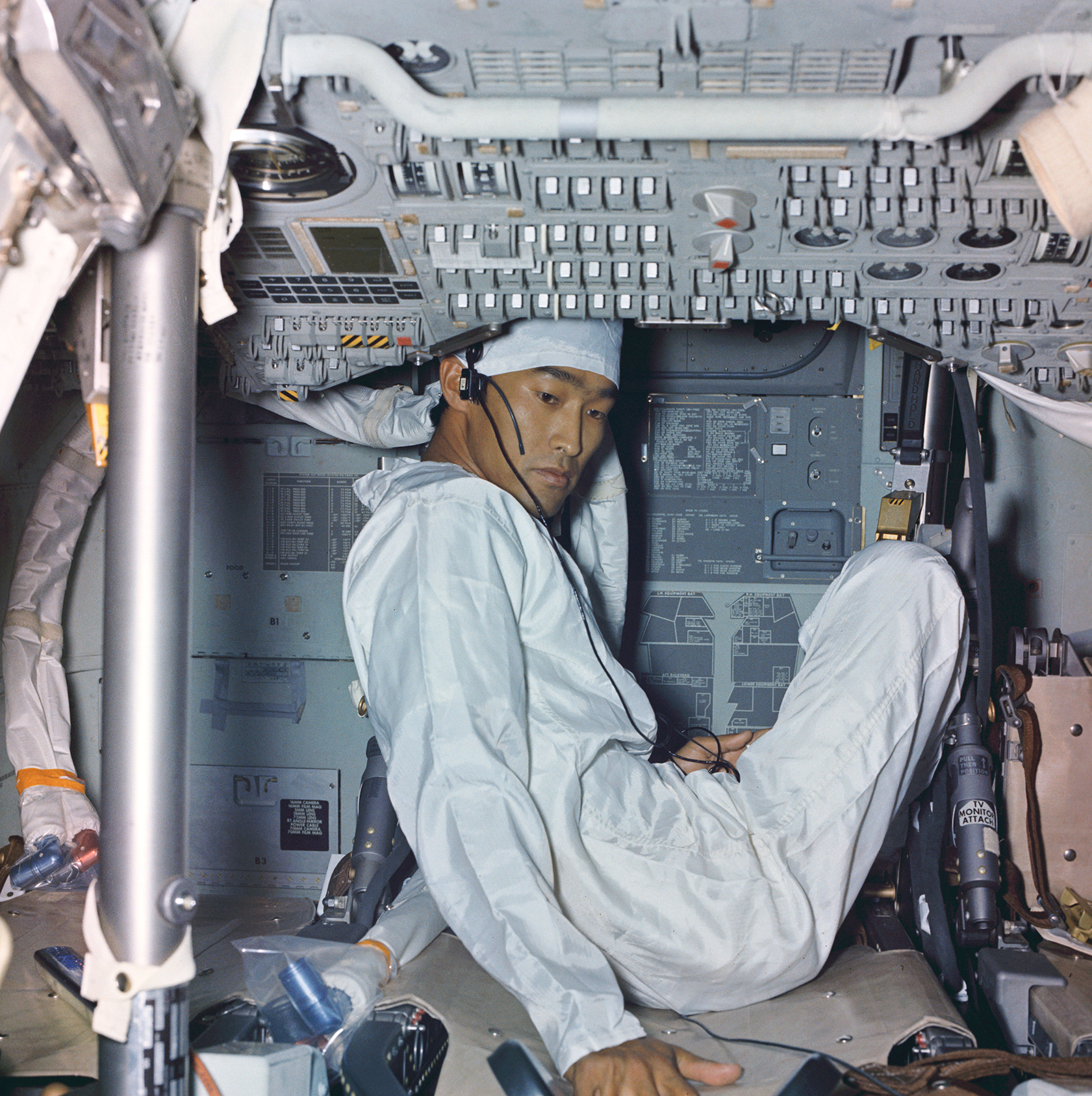 All three Apollo 11 astronauts were quarantined for several weeks following the mission at the Lunar Receiving Laboratory at the Johnson Space Center in Texas. Quarantined with them was a photographer and technician, John Hirasaki, who was given the job of removing essential items from the Command Module and decontaminating the interior. This image was taken during the quarantine period and shows the condition of the cabin shortly after its arrival back in the country. Note the calendar visible just to the left of Hirasaki. Photo: NASA 