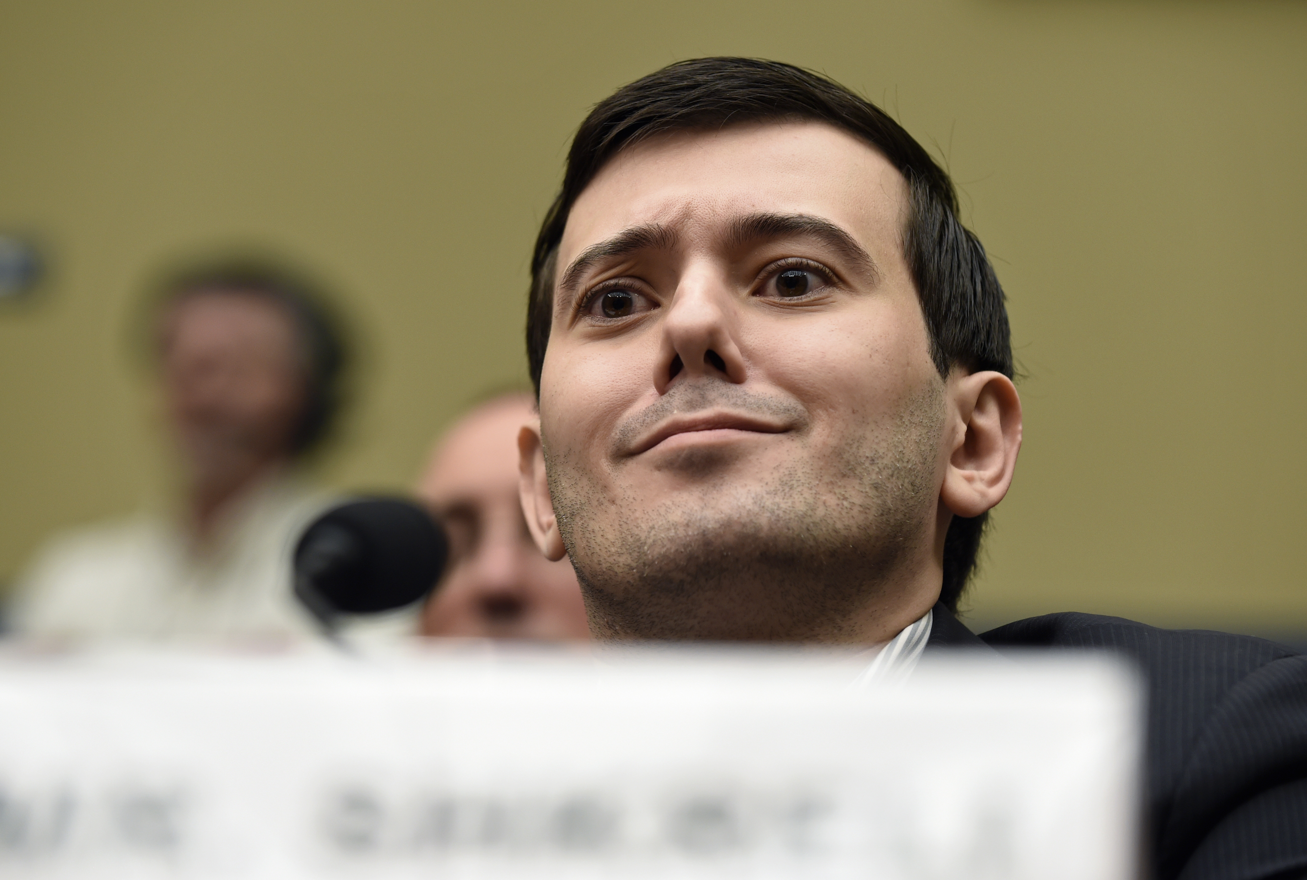 Pharmaceutical chief Martin Shkreli listens on Capitol Hill in Washington, Thursday, Feb. 4, 2016, during the House Committee on Oversight and Reform Committee hearing on his former company's decision to raise the price of a lifesaving medicine. Shkreli refused to testify before U.S. lawmakers who excoriated him over severe hikes for a drug sold by a company that he acquired. (AP Photo/Susan Walsh)