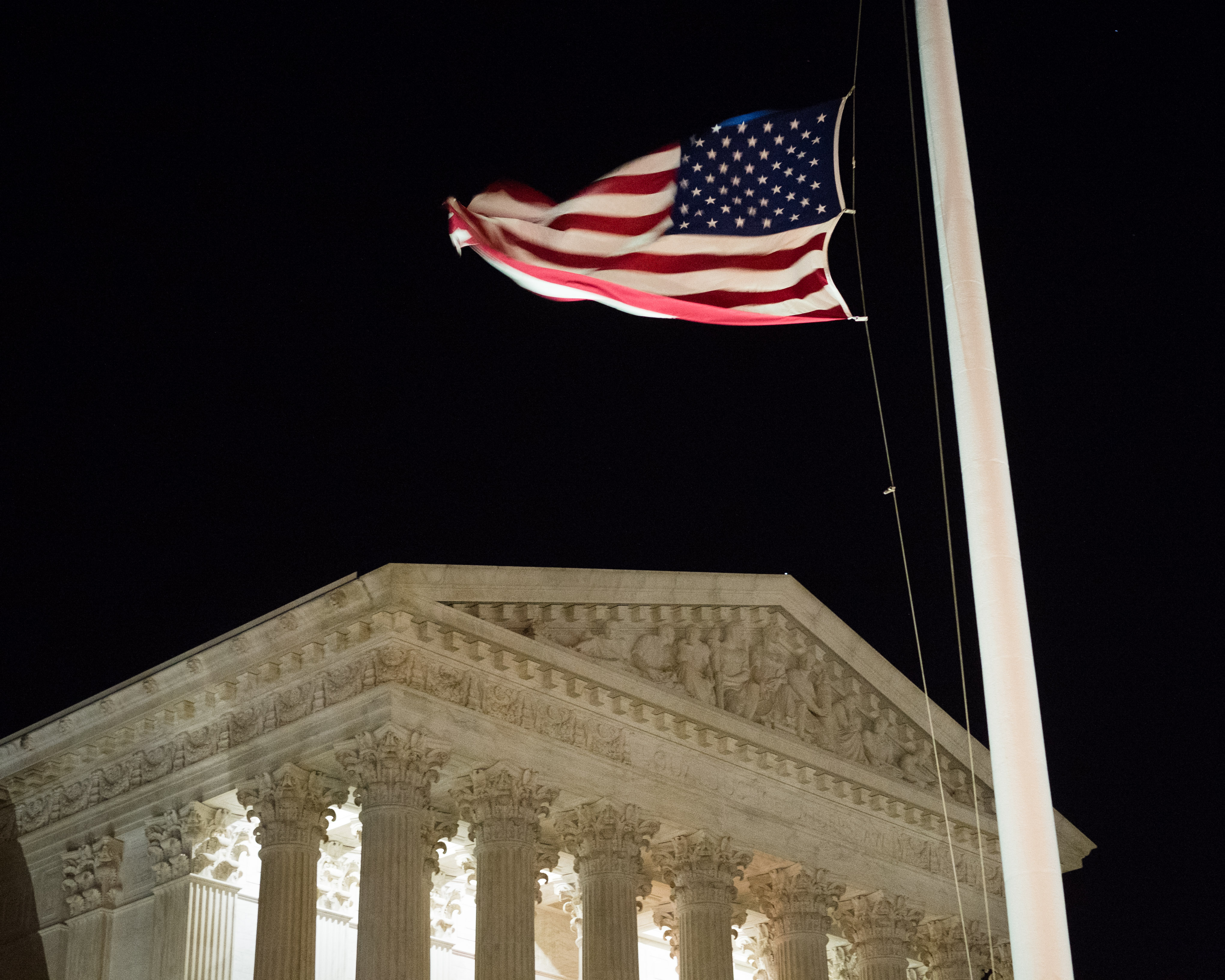 A U.S. flag flies at half-staff in front of the U.S. Supreme Court in Washington Saturday, Feb. 13, 2016, after is was announced that Supreme Court Justice Antonin Scalia, 79, had died. (AP Photo/J. David Ake)