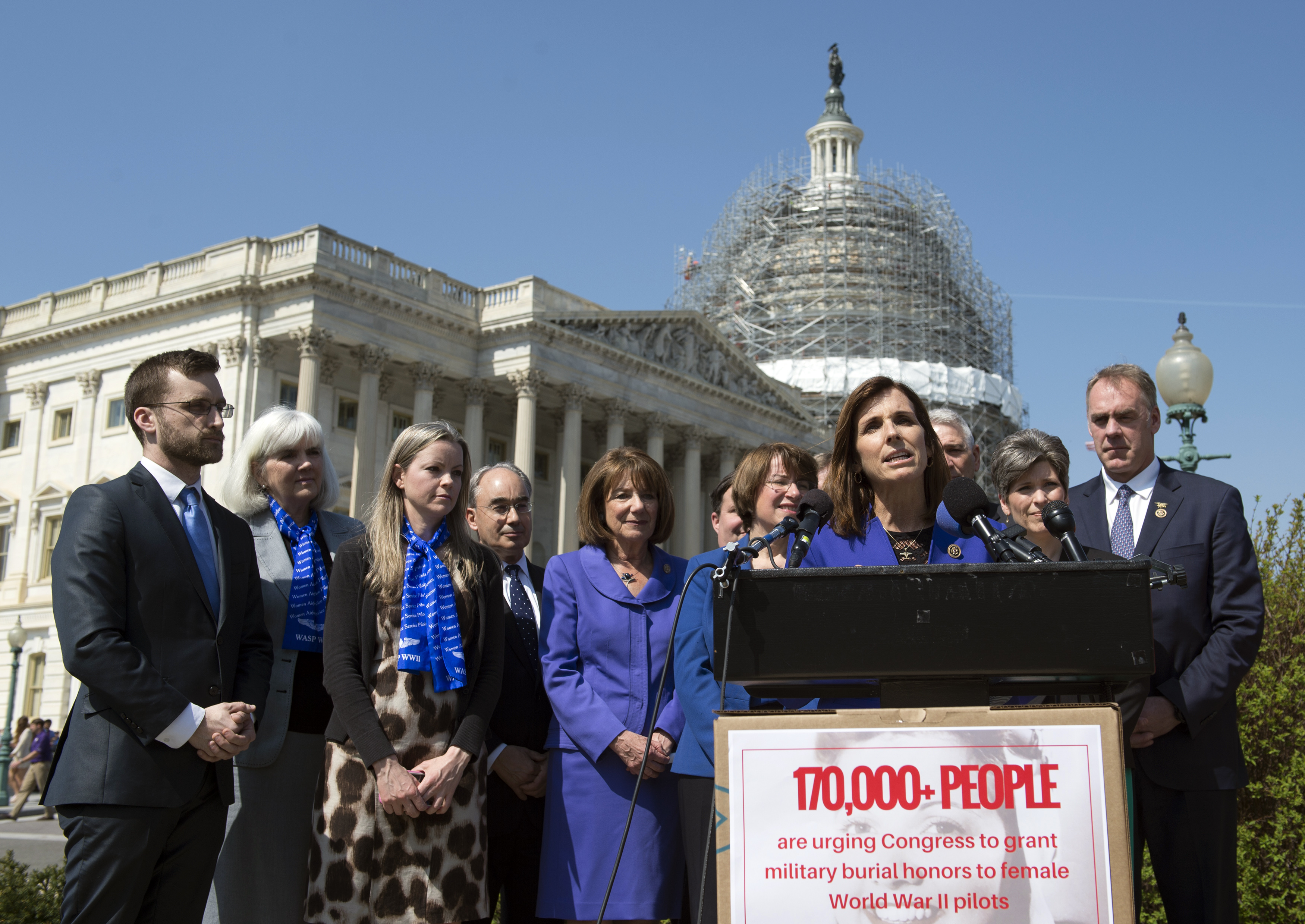 Rep. Martha McSally, R-Ariz., speaks during an event on the reinstatement of WWII female pilots at Arlington National Cemetery on Capitol Hill in Washington, Wednesday, March 16, 2016. Joining the effort are Terry Harmon, second from left, daughter of WWII veteran WASP (Women Airforce Service Pilots) Elaine Harmon and Erin Miller, third from left, granddaughter of Elaine Harmon. Arlington National Cemetery approved in 2002 active duty designees, including WASP pilots, for military honors and inurnments. However, in March 2015, then-Secretary of the Army John McHugh reversed this decision. (AP Photo/Molly Riley)