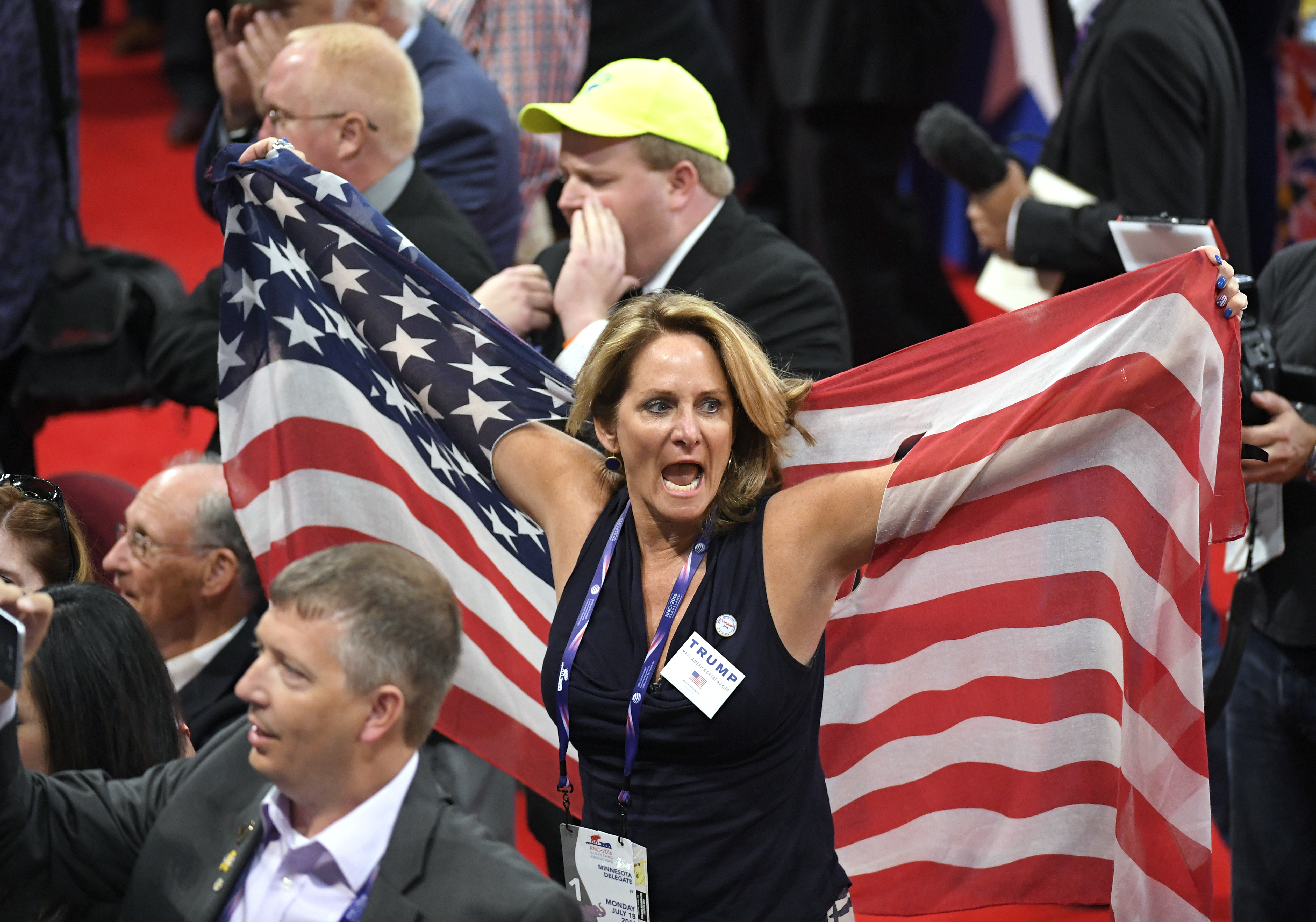 Delegates react as some delegates call for a roll call vote on the adoption of the rules during the opening day of the Republican National Convention in Cleveland, Monday, July 18, 2016. (AP Photo/Mark J. Terrill)