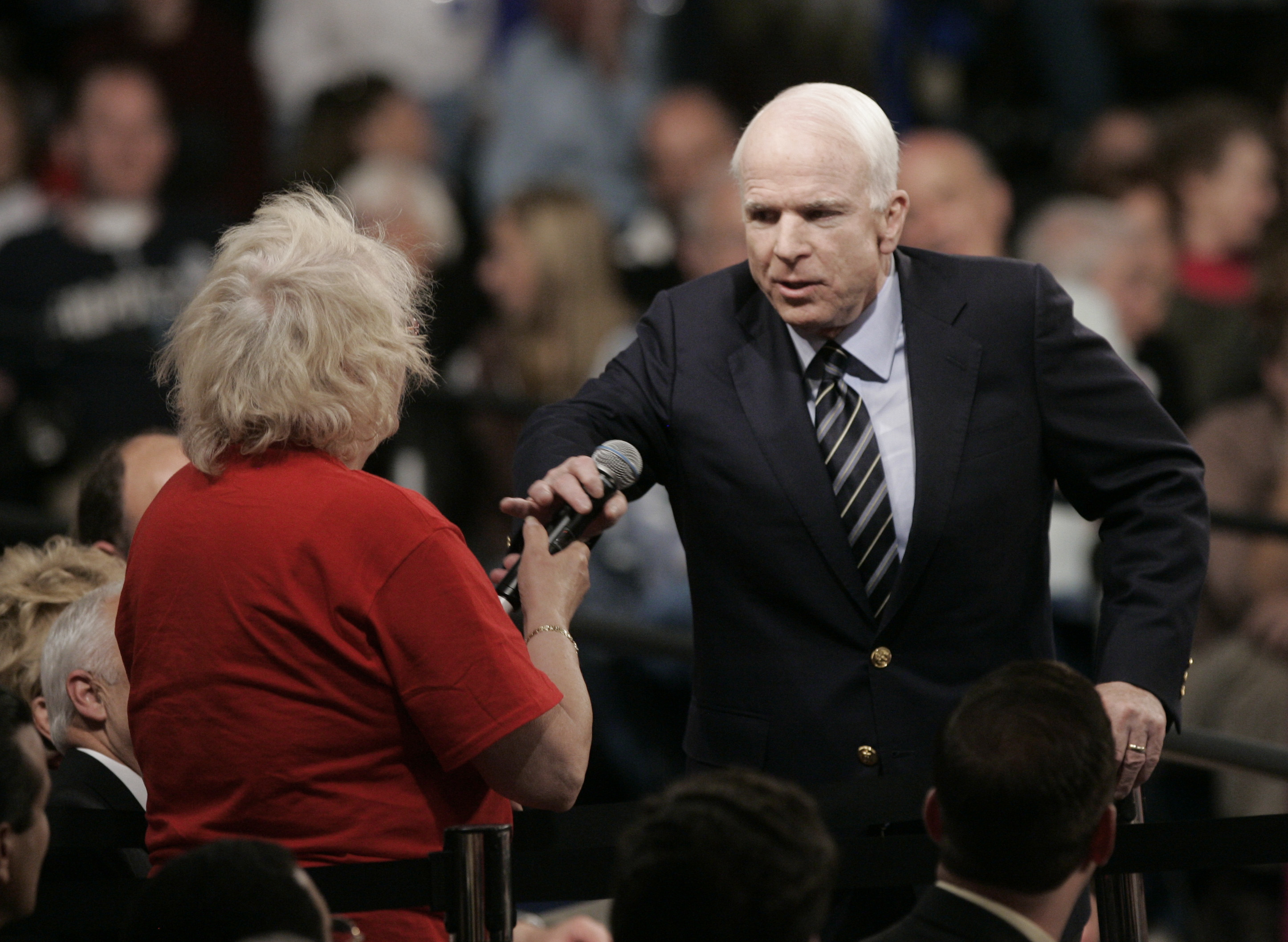 Republican presidential candidate Sen. John McCain, R-Ariz., right, takes back the microphone from Gayle Quinnell who said she read about Sen. Barack Obama and "that he was an Arab," during a question and answer time at a town hall meeting at Lakeville South High School Friday, Oct. 10, 2008 in Lakeville, Minn. (AP Photo/Jim Mone)