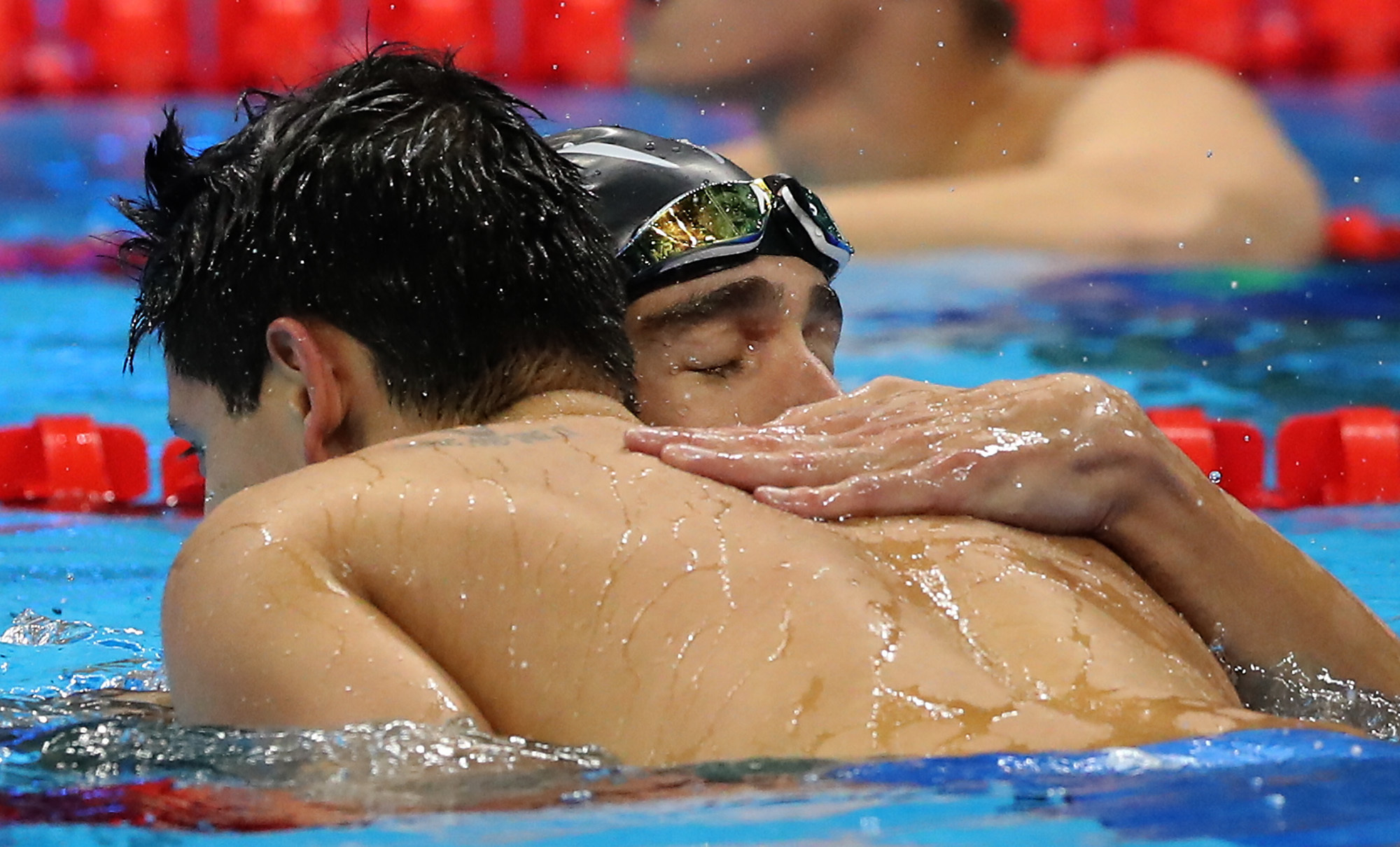 United States' Michael Phelps congratulates Singapore's gold medal winner Joseph Schooling after the men's 100-meter butterfly final during the swimming competitions at the 2016 Summer Olympics, Friday, Aug. 12, 2016, in Rio de Janeiro, Brazil. (AP Photo/Lee Jin-man)