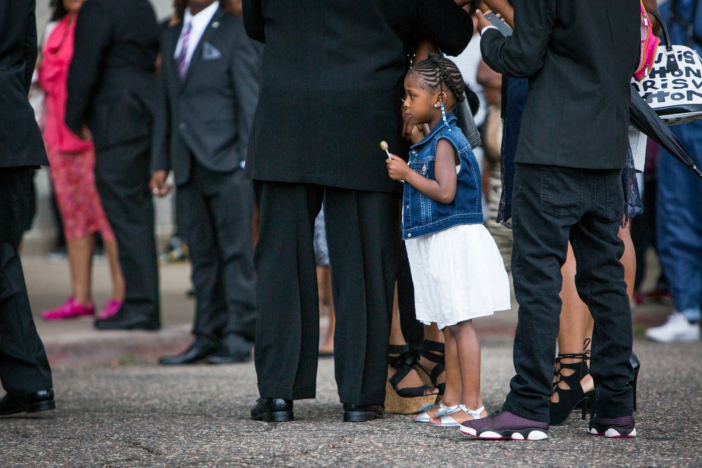 Diamond Reynolds' daughter, Dae'Anna, holds her mother's hand before heading into Philando Castile's funeral in July. Evan Frost | MPR News | File.