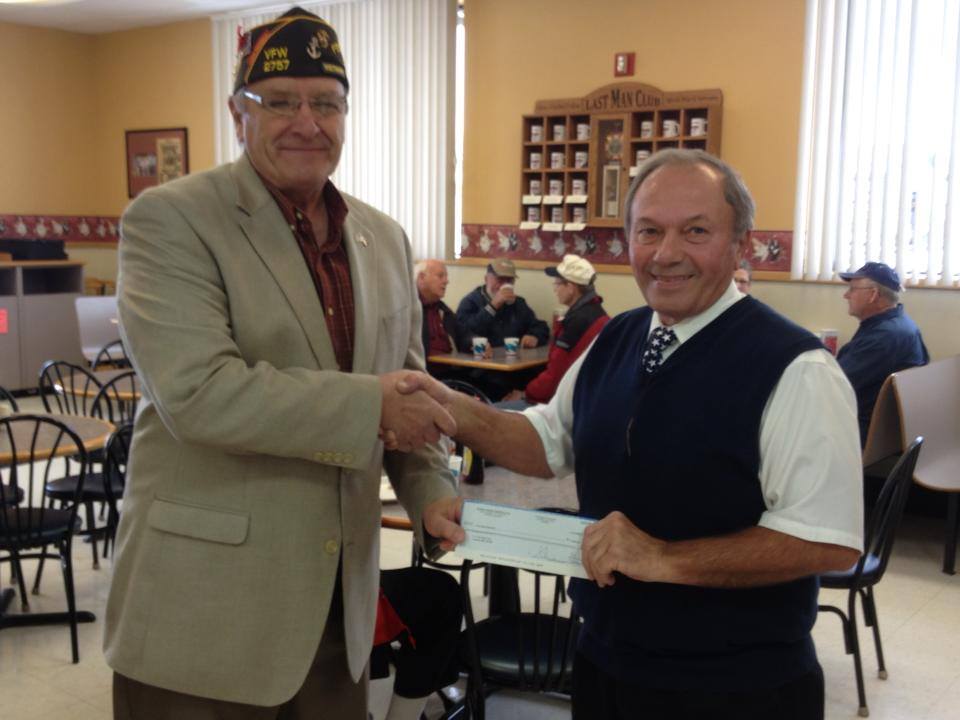 Glen Gust, right,  shown in 2014 while presenting a check to Luverne's VFW to be used for veterans' programs.  Photo: Glen's Food Center Facebook page.