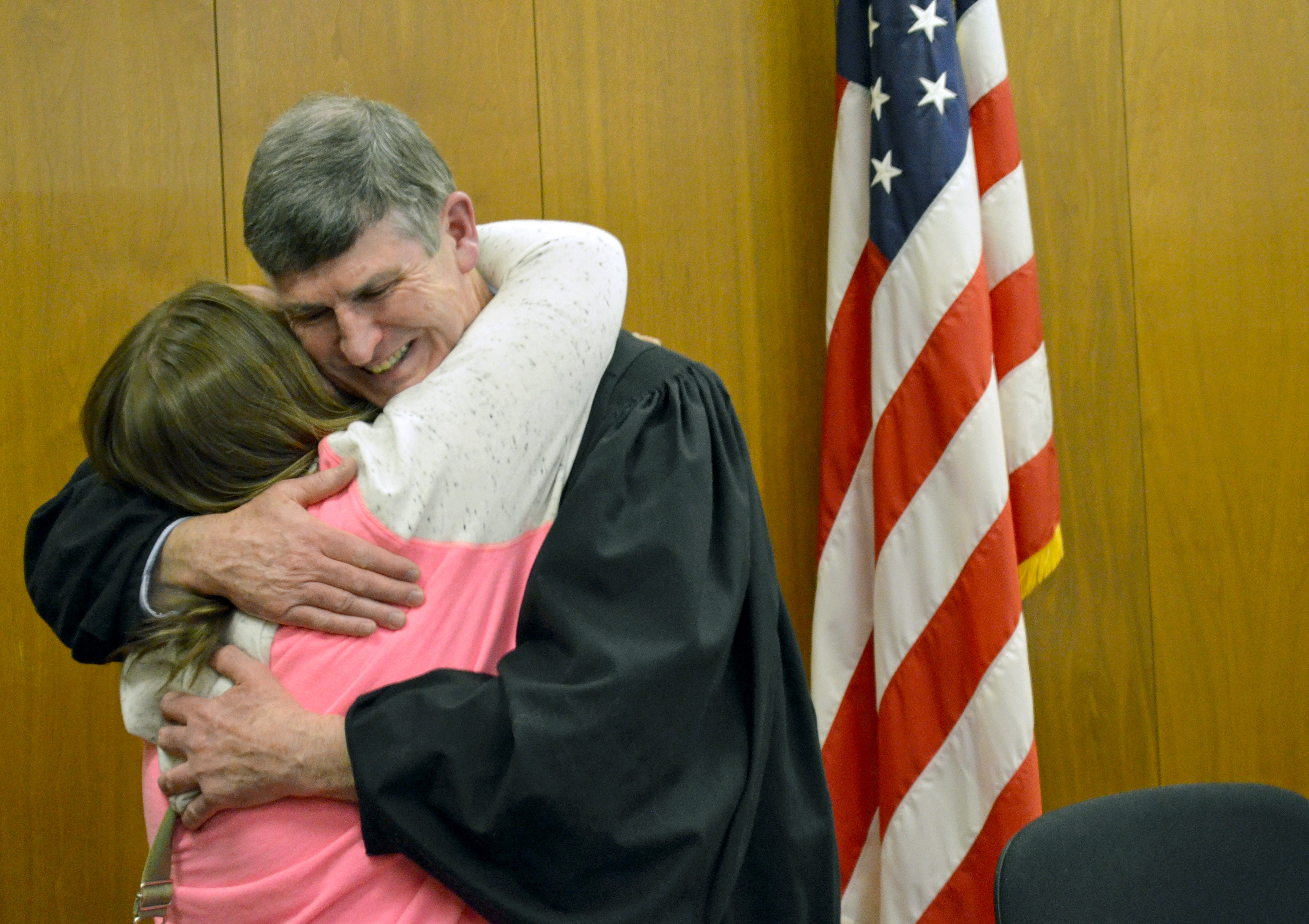 Judge Larry Collins gives Ashly Sylvester, Steele Waseca Drug Court's first graduate, a big hug Jan. 19. Sylvester returned to help congratulate the retiring Collins. (Suzanne Rook/Waseca County News) 