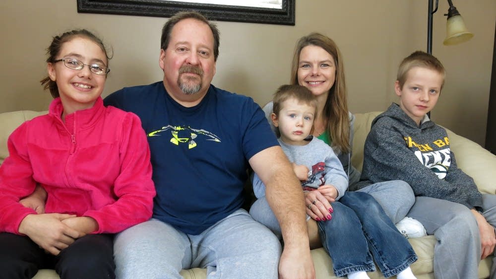 John and Cindy Ness sit with three of their children, Tiena, Zack and Noah in their home south of Bemidji on Dec. 27, 2016. For the last 17 years, the Ness family has hosted dozens of foster children. John Enger | MPR News