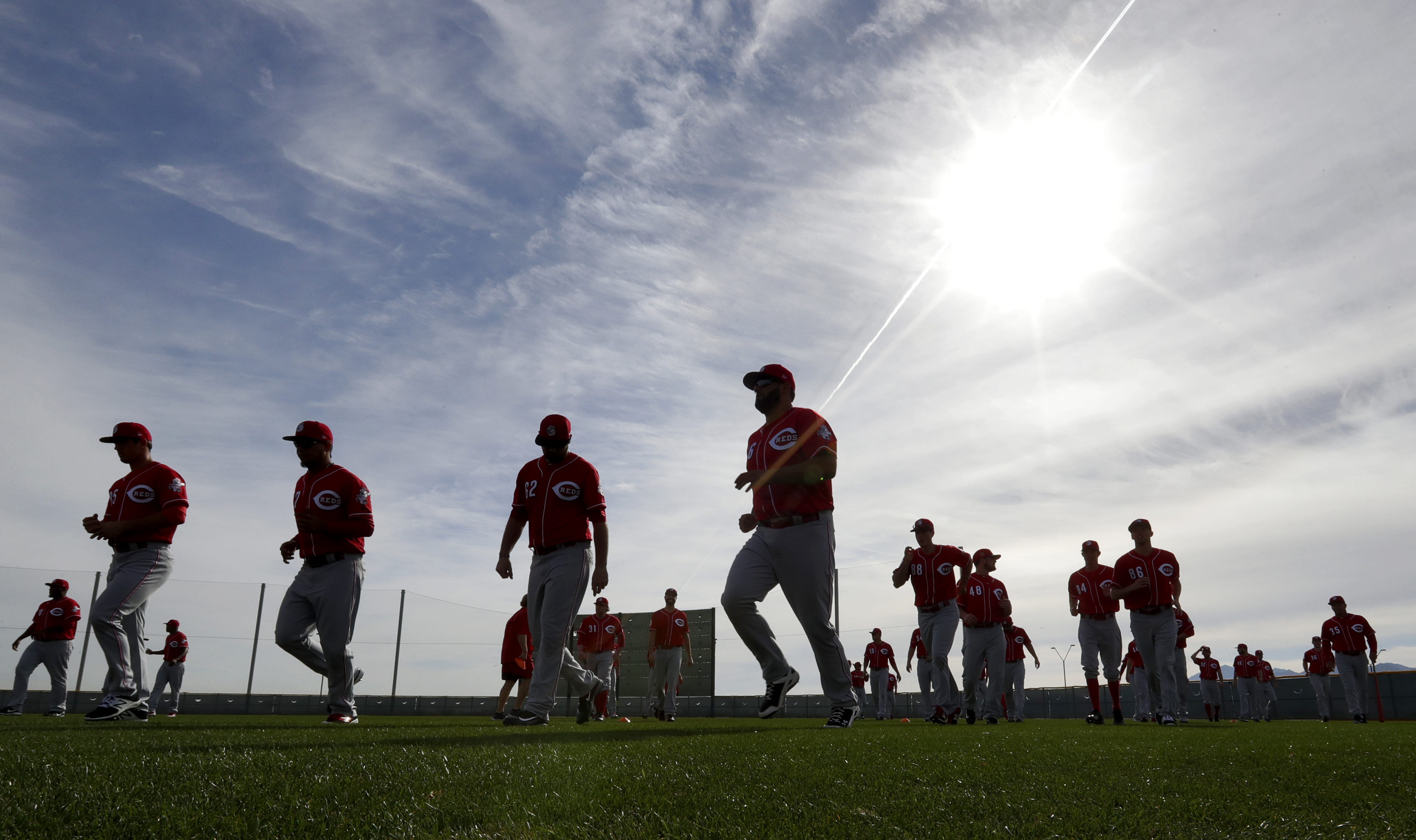 The Cincinnati Reds take the field for their first day of spring training baseball workouts, Tuesday, Feb. 14, 2017, in Goodyear, Ariz. (AP Photo/Matt York)