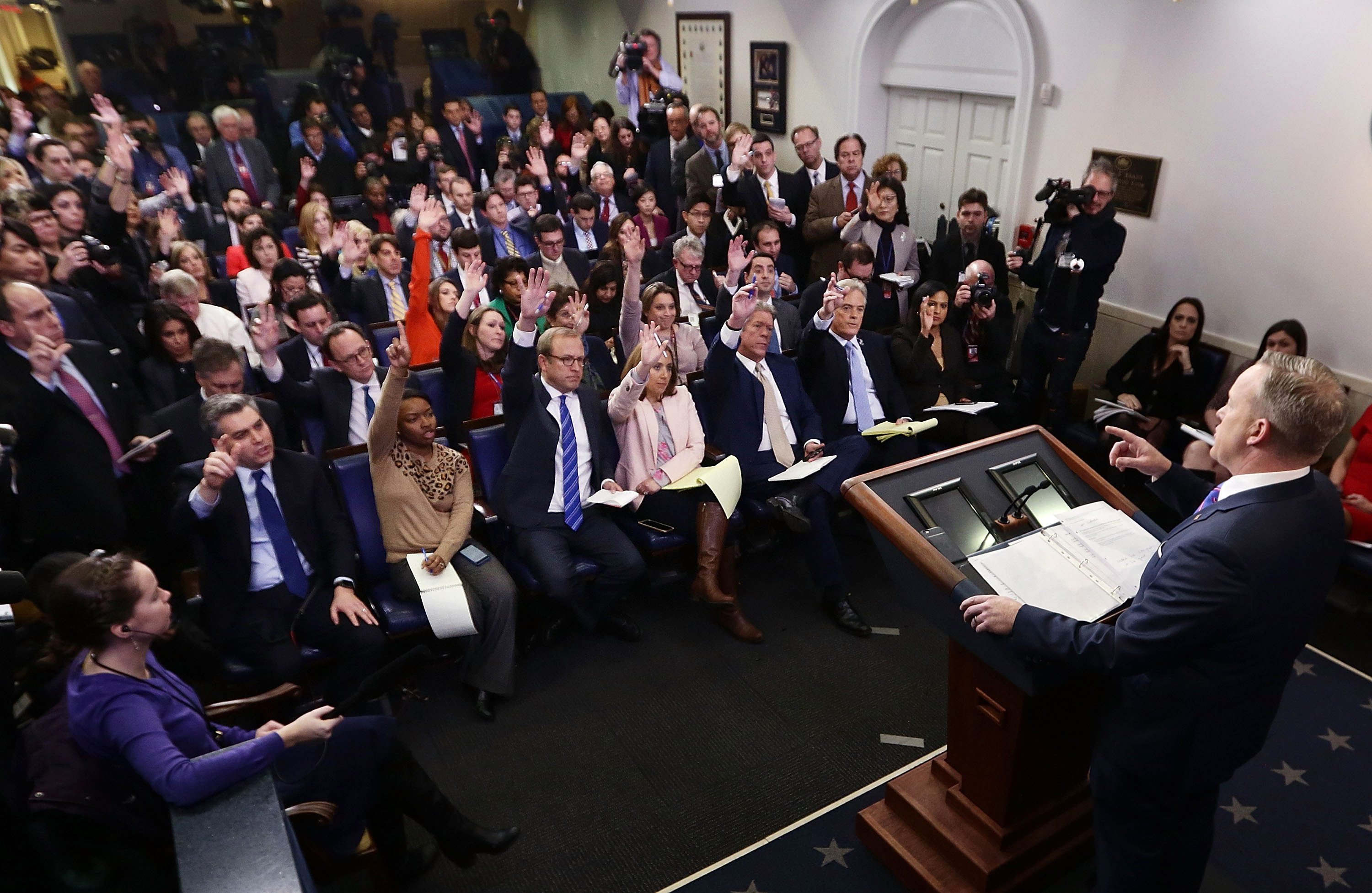 Reporters and broadcasters try to ask questions during White House press briefing. Photo by Alex Wong/Getty Images.