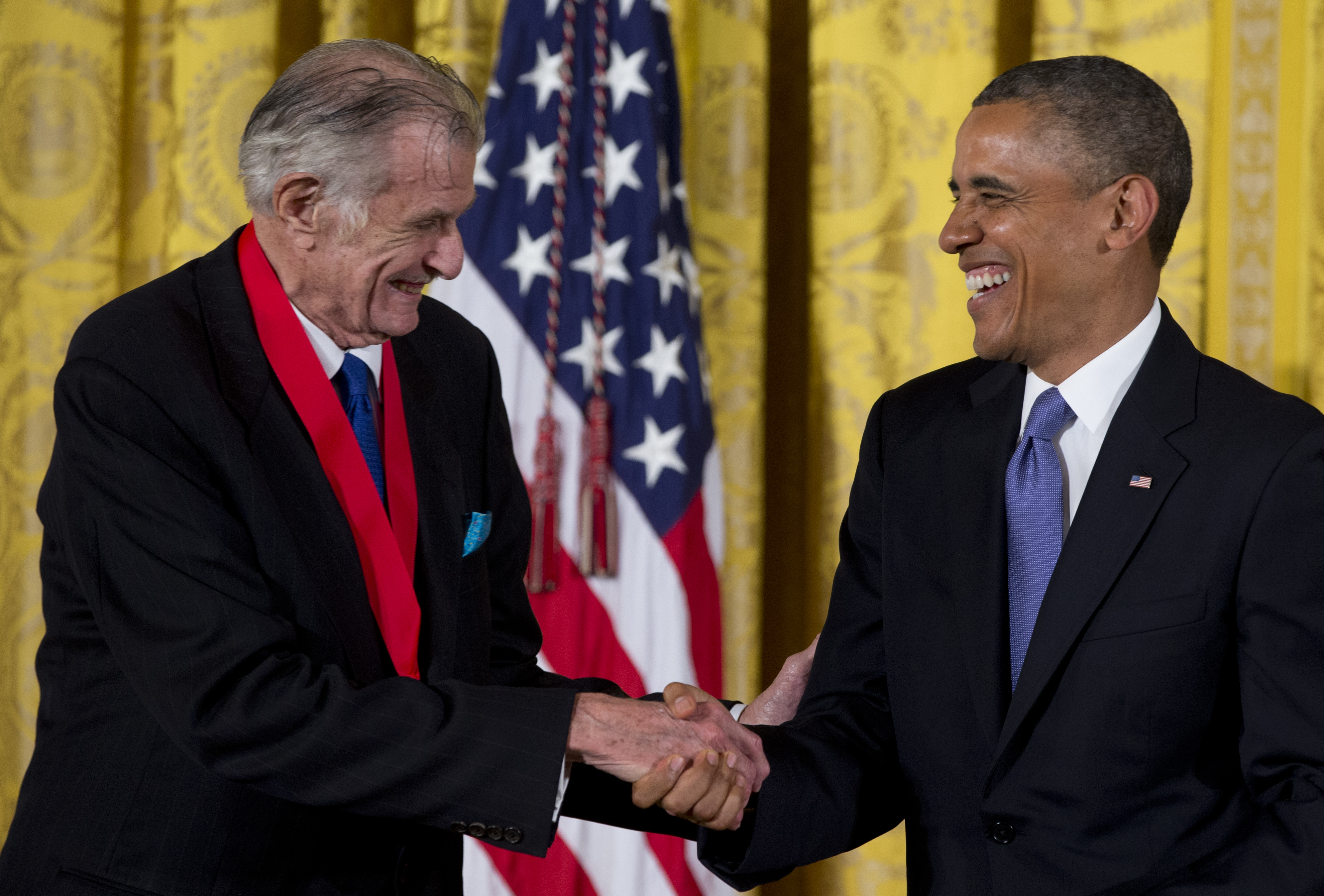 President Barack Obama laughs with Frank Deford as he awards him the 2012 National Humanities Medal for transforming how we think about sports, during a ceremony in the East Room of White House, Wednesday, July 10, 2013, in Washington. Carolyn Kaster | AP | File.