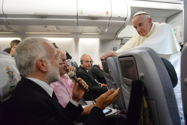 Pope Francis (R) speaks with journalists during a long press conference held aboard the papal flight on their way back to Italy upon departure from Rio de Janeiro in Brazil, on July 28, 2013. (LUCA ZENNARO/AFP/Getty Images)